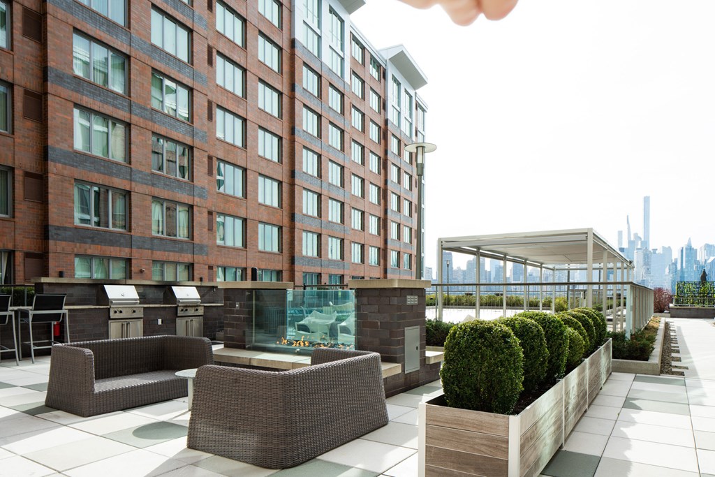 a communal terrace with a view of the city