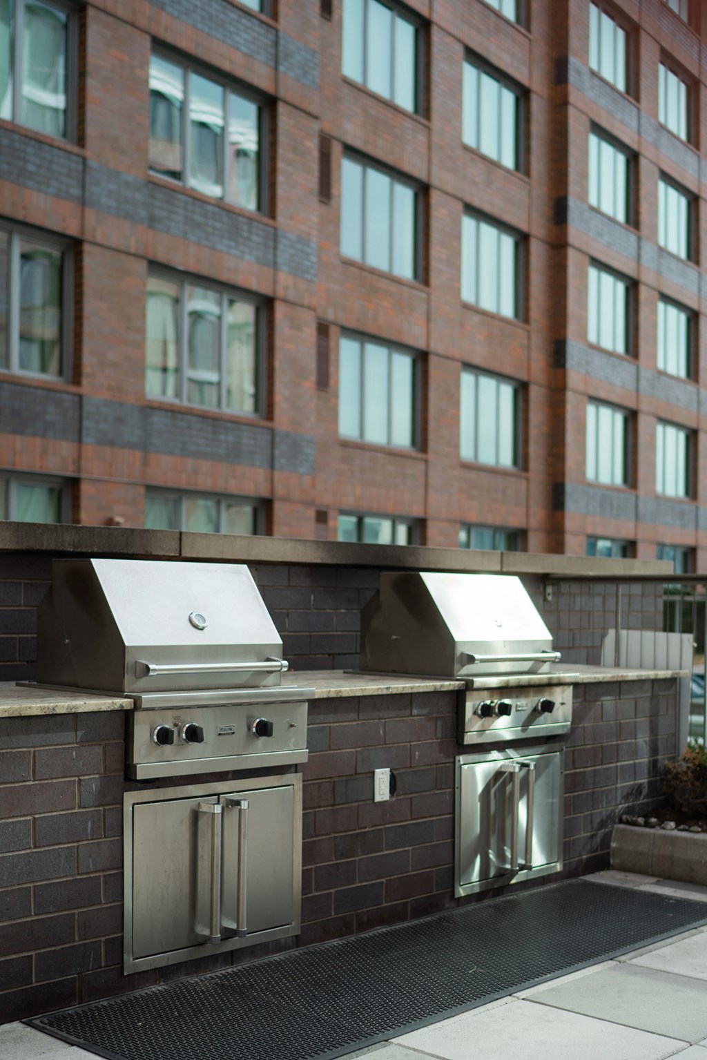 a barbecue grill on the side of a building