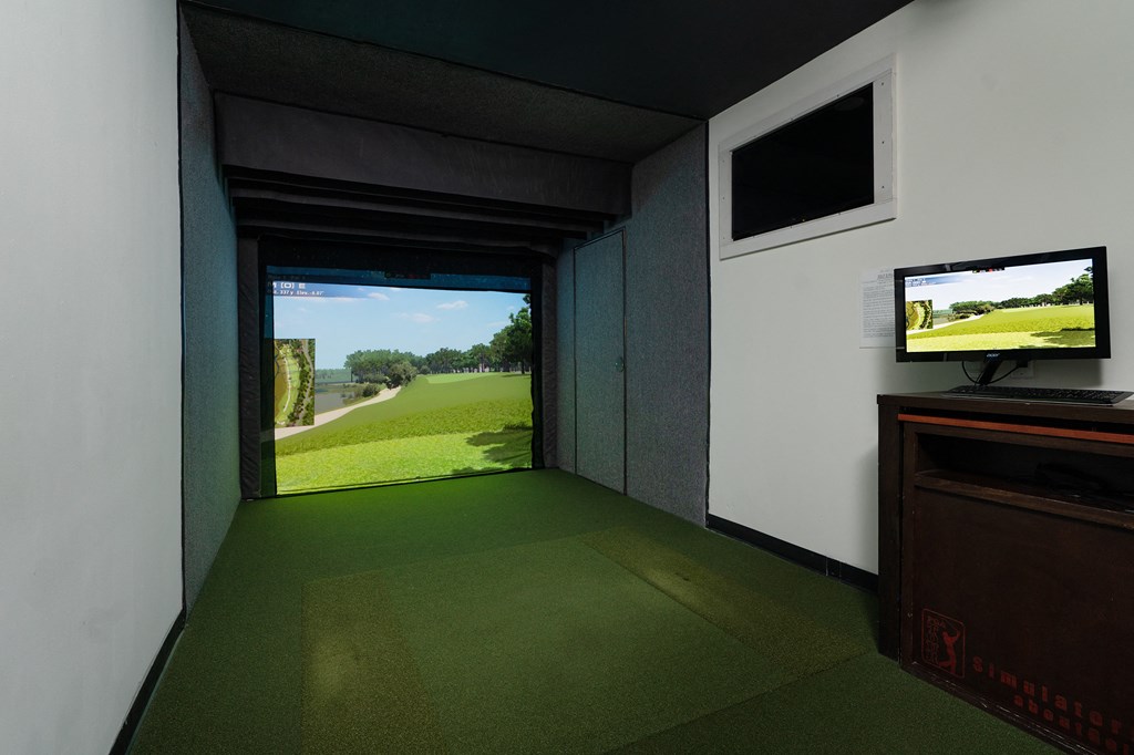 a room with a television and a view of a golf course