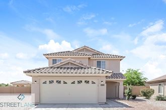 a view of the front of a house with a garage door