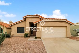 a home with a driveway and a street alliance homes logo