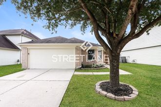 a tree in a yard in front of a house