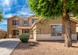 a house with a tree and a driveway