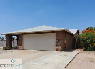 a garage door in front of a brick house
