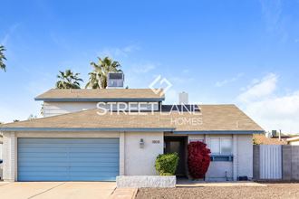 a building with a garage door and a sign that reads street avenue homes