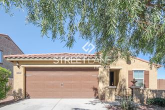 a house with a garage door and a tree
