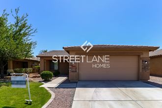 a streetlane homes building with a driveway and a sign on the side of it