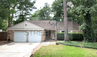 a white brick house with a blue garage door