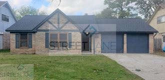 front view of a brick house with a blue garage door