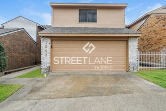 a garage door with a street advance homes sign on it