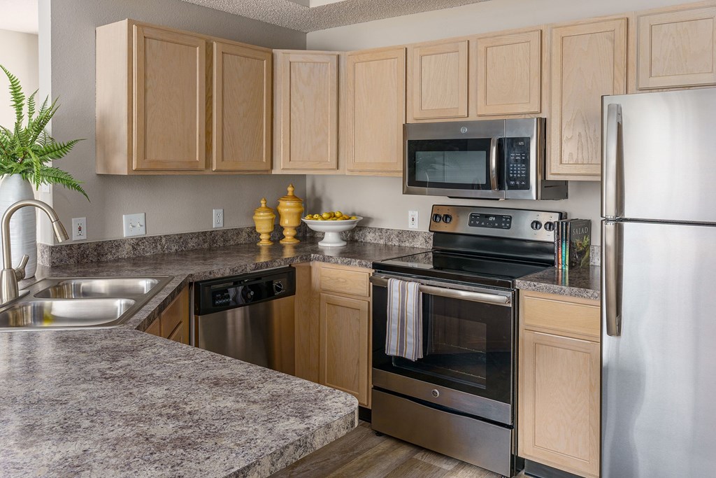 a kitchen with stainless steel appliances and granite counter tops