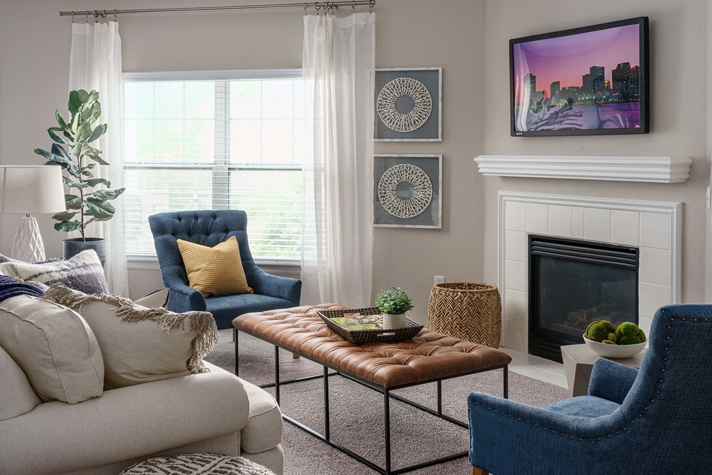 a living room filled with furniture and a fireplace