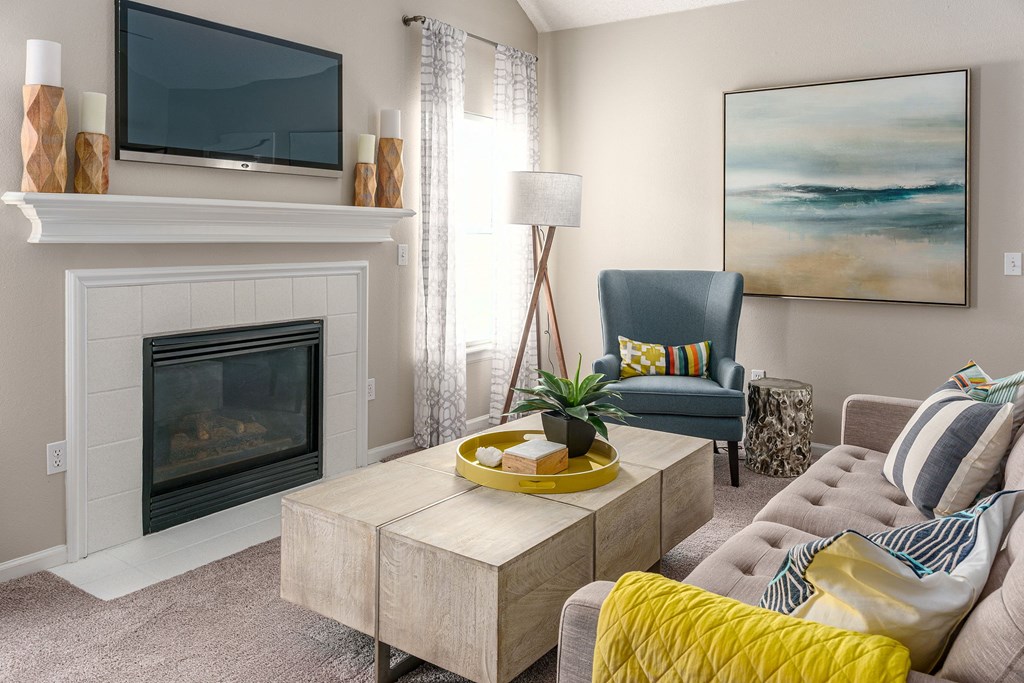 a living room with a fireplace and a couch and a table