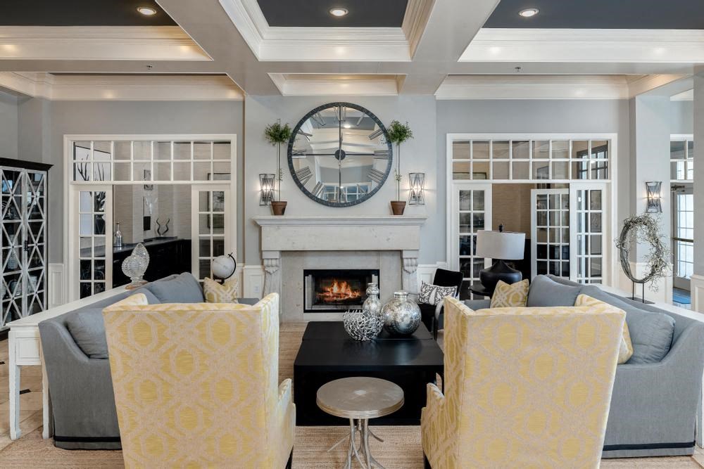 a living room with a fireplace and a large clock on the wall