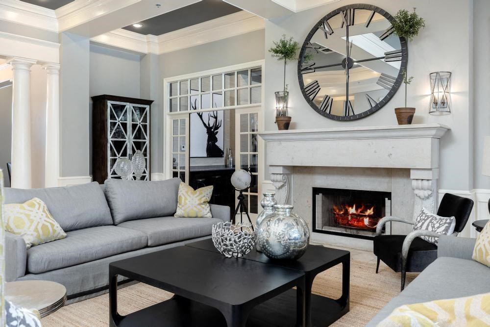 a living room with a fireplace and a large clock on the wall