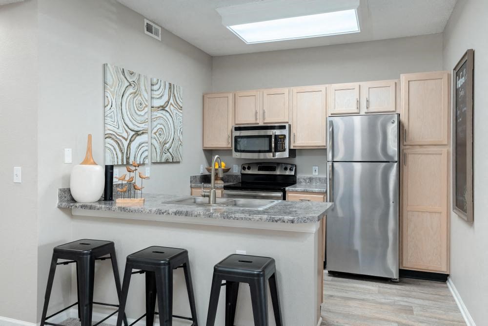 a kitchen with stainless steel appliances and bar stools