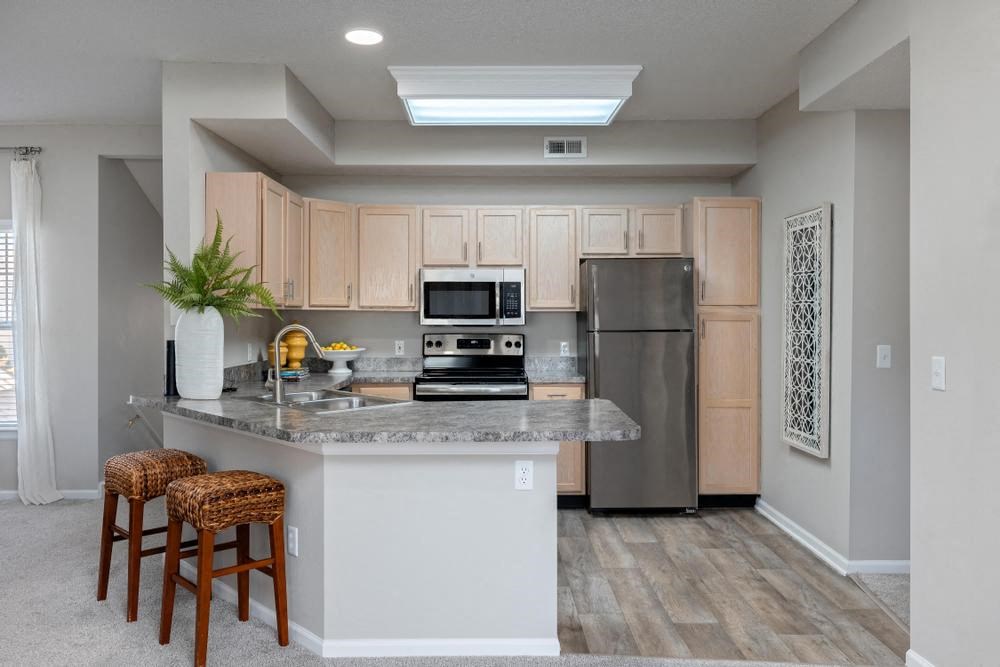 a kitchen with a island and stainless steel appliances