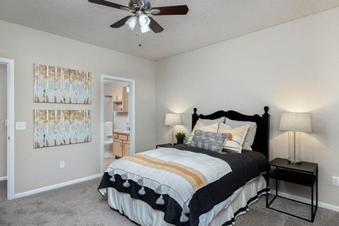 a bedroom with a bed and a ceiling fan