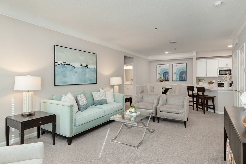 a living room with couches and chairs and a table