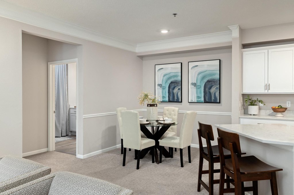a dining room and kitchen with a table and chairs