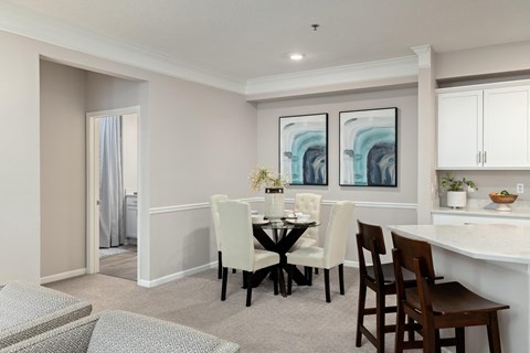 a dining room and kitchen with a table and chairs