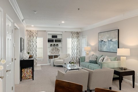 a living room with a couch and chairs and a table