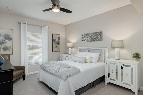 a bedroom with a bed and a ceiling fan