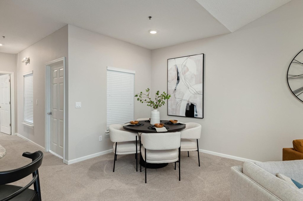 a dining room with a table and chairs