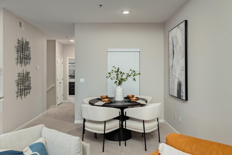 an open living room with a dining room table and chairs