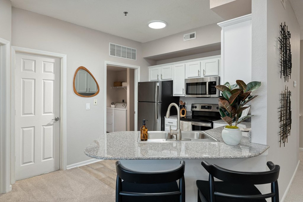 a kitchen with a marble counter top and a sink