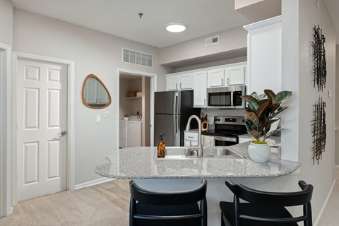 a kitchen with a marble counter top and a sink