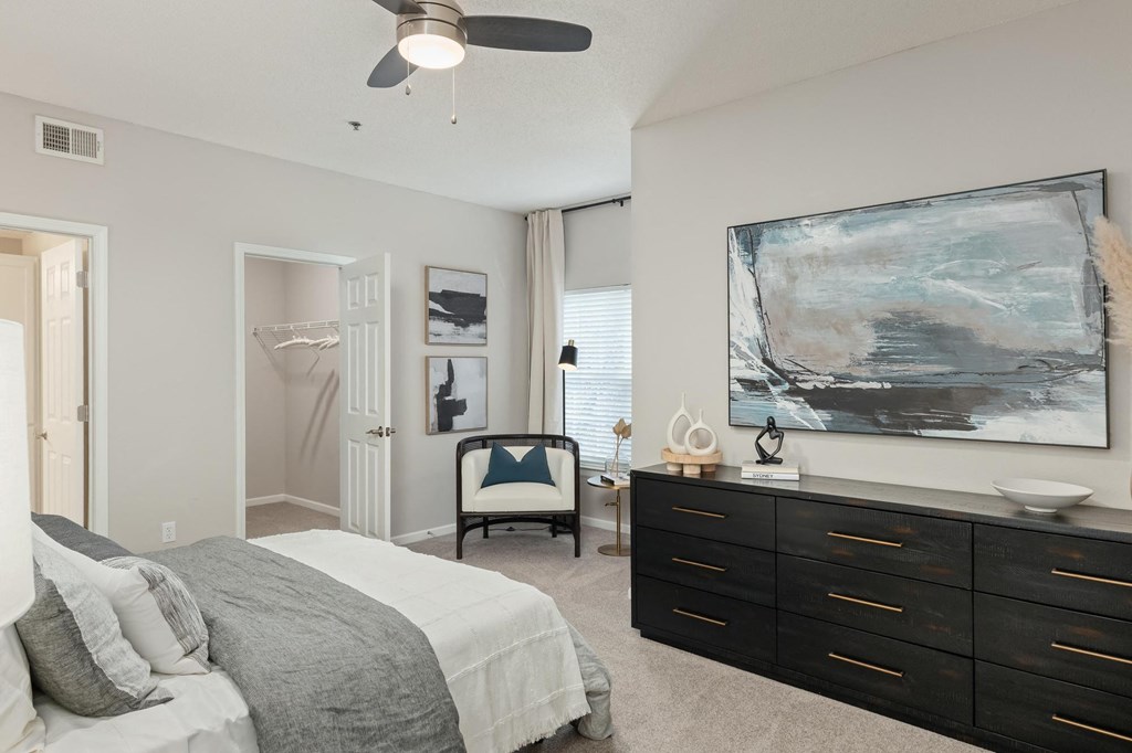 a bedroom with a bed and a dresser