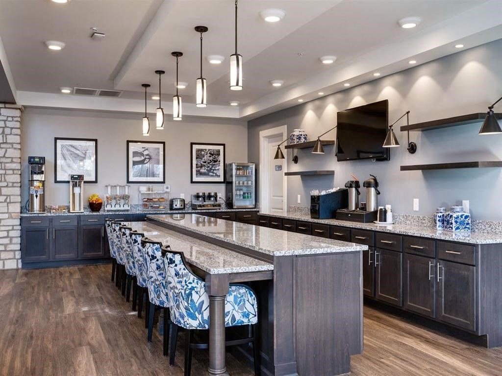 a large bar in a restaurant with a row of chairs