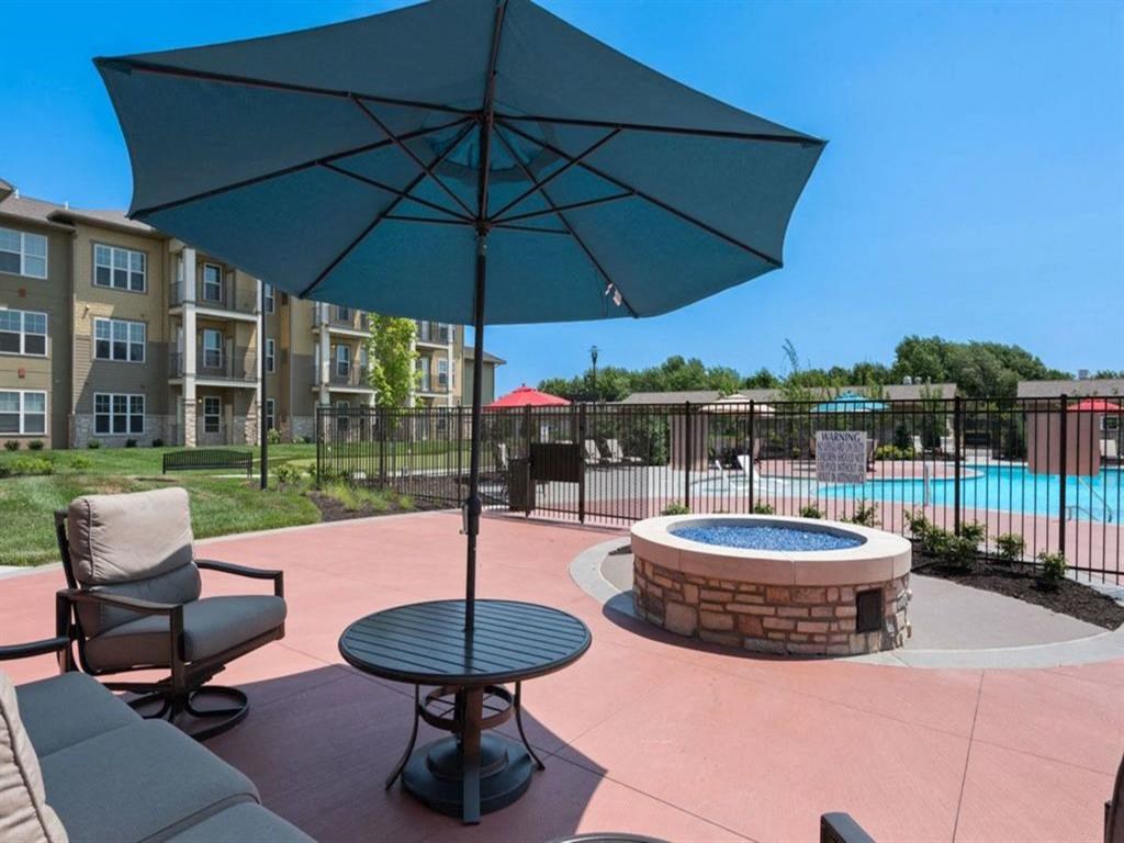 our apartments have a pool and a patio with an umbrella