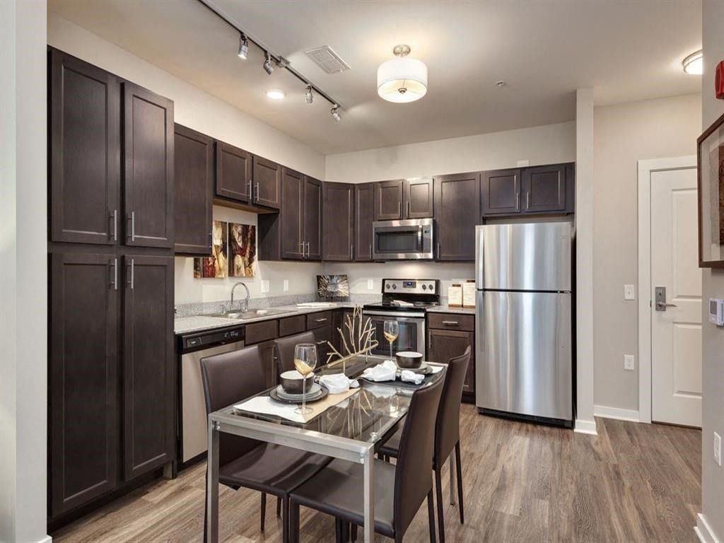 a kitchen and dining room with stainless steel appliances