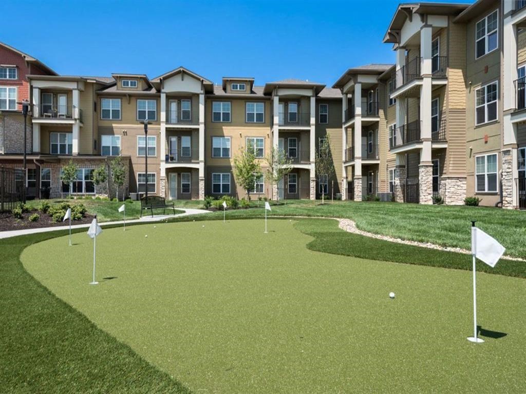 a mini golf course in front of an apartment building