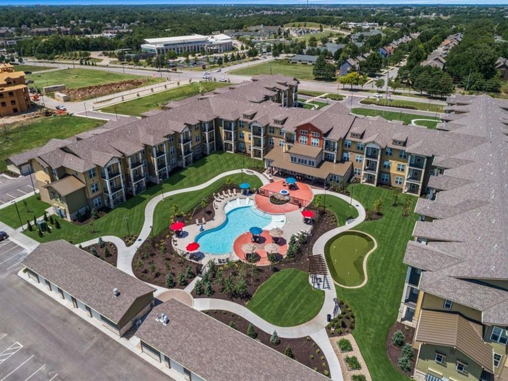 an aerial view of an apartment complex with a swimming pool
