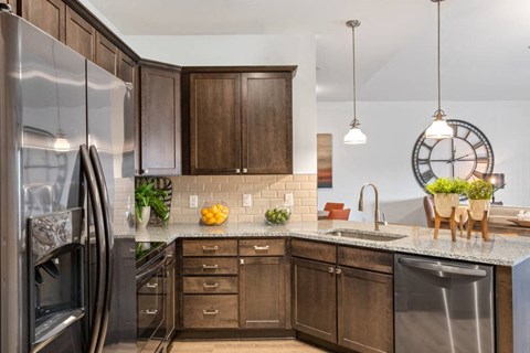 a kitchen with wooden cabinets and stainless steel appliances