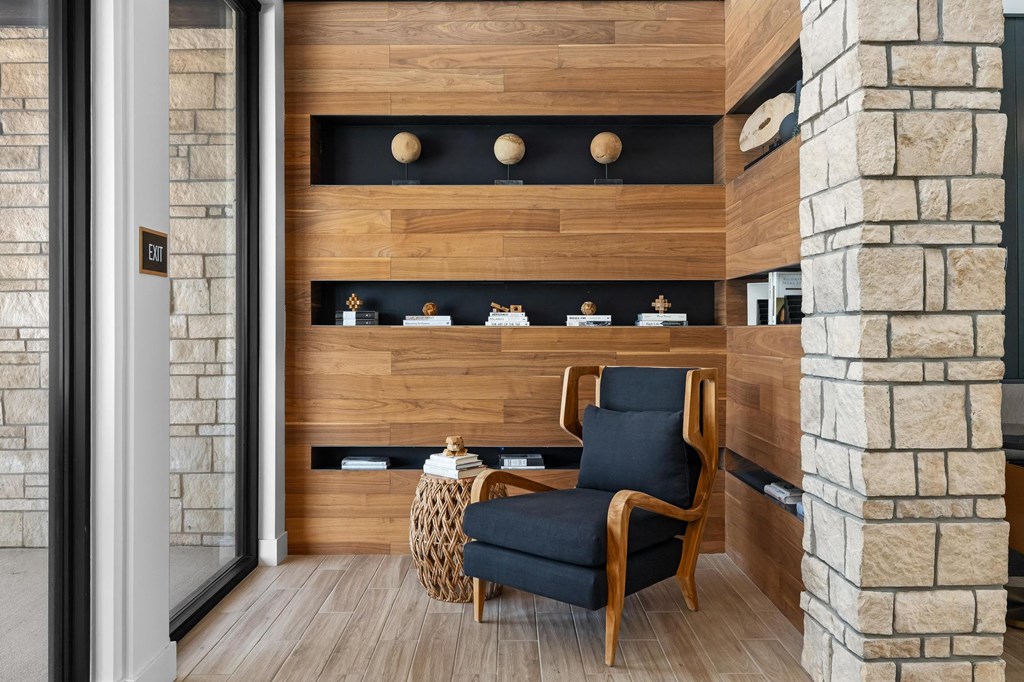 a living room with a chair and a wooden wall