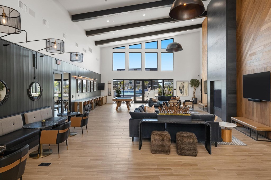 a large living room with a large table and chairs and a fireplace