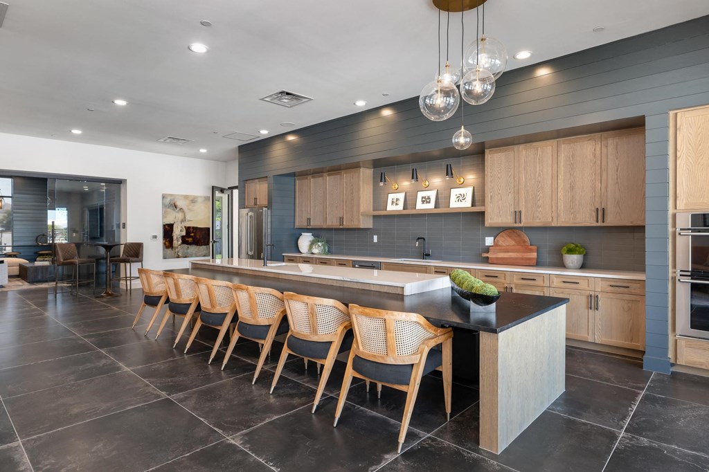 a large kitchen with a large island with chairs