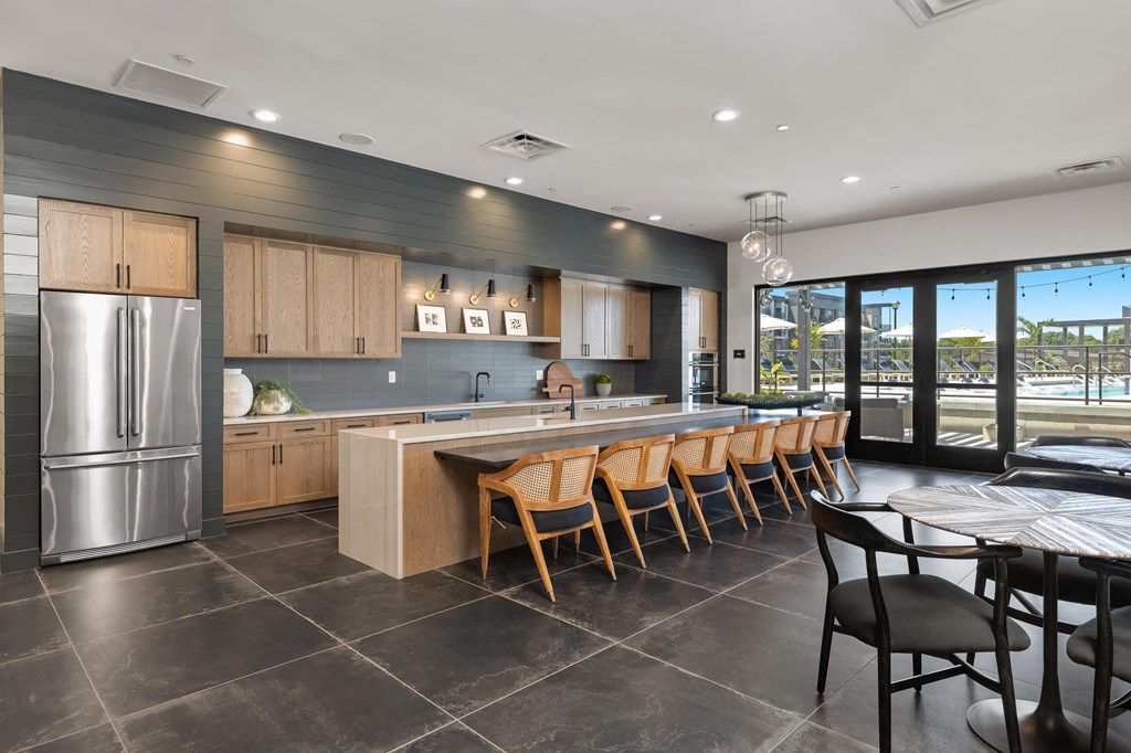 a kitchen with a large island and a table with chairs