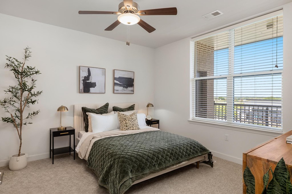 a bedroom with a bed and a ceiling fan