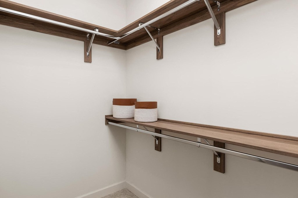 a washer and dryer in a laundry room with a wooden shelf