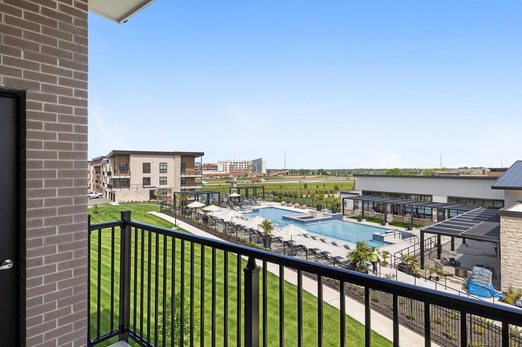 a view of the pool from a balcony at the resort