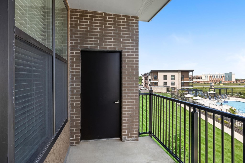 balcony with view of pool and city buildings at the preserve at greatstone