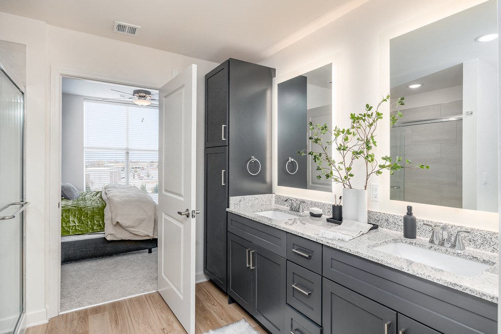 a black and white bathroom with two sinks and a mirror