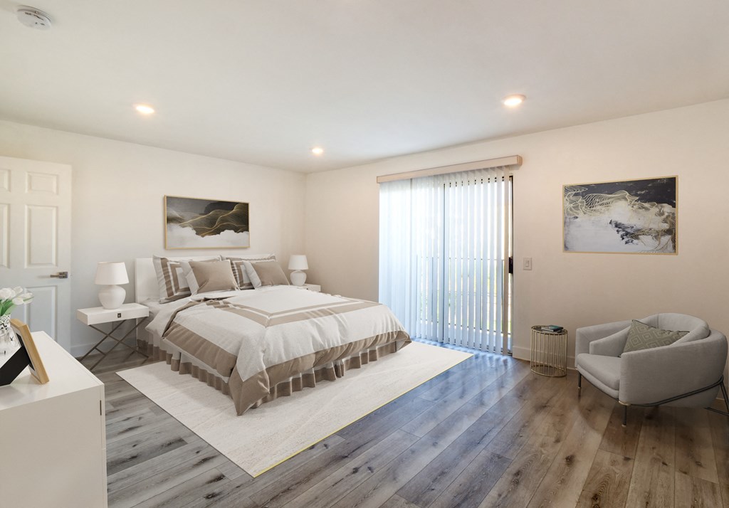 a white bedroom with a bed and a sliding glass door