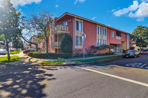 an apartment building on the corner of a street