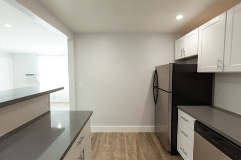 a kitchen with black appliances and white cabinets